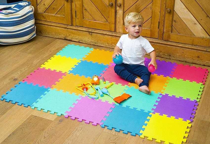 baby playing on foam floor mats