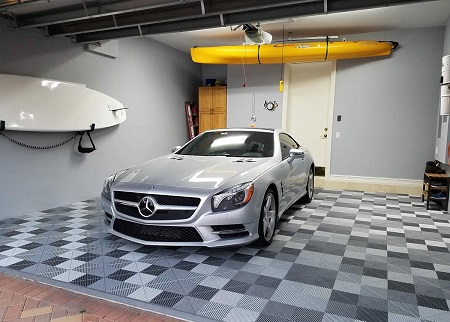 Garage with black and white checkered floor tiles and parked cars