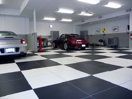 Garage with checkered tiles and a parked Mercedes