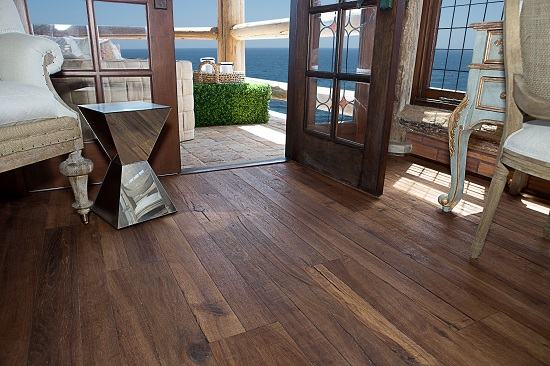 Dark rustic engineered wood flooring in a coastal room with ocean views