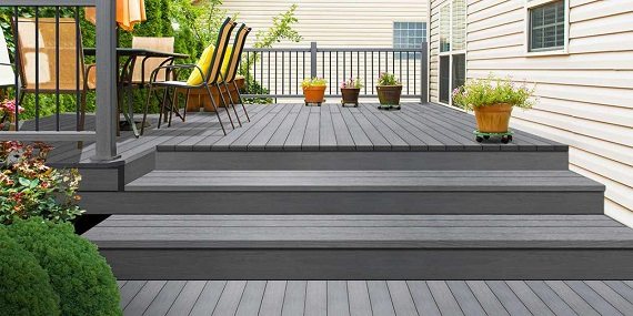 Grey composite deck with steps and outdoor seating