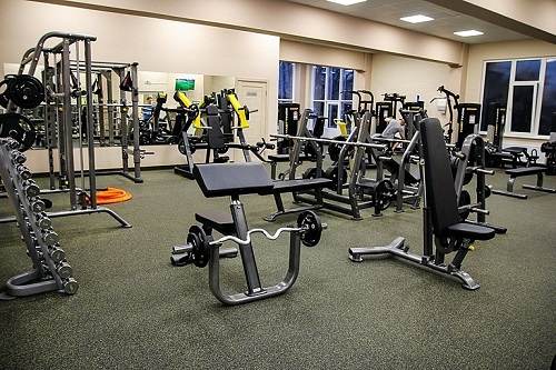 Gym with strength machines on textured rubber flooring