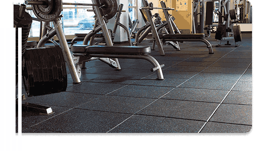 Gym with weight machines on rubber tile flooring