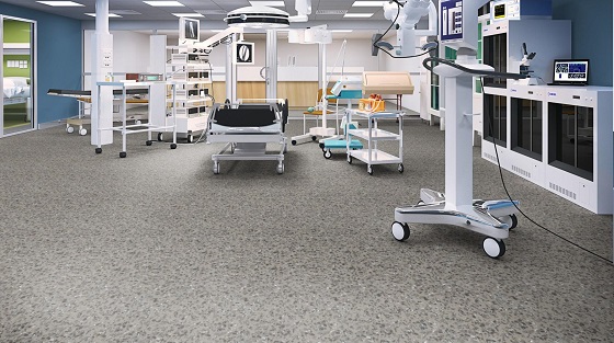 Hospital operating room with medical equipment and speckled flooring