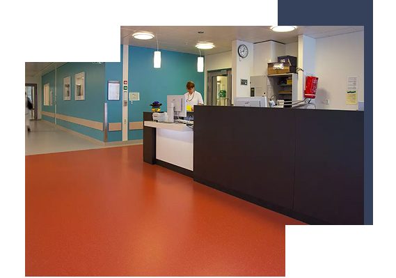 Hospital reception area with bright red flooring and blue wall background