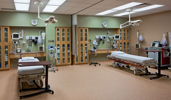 Hospital treatment room with medical equipment and patient beds