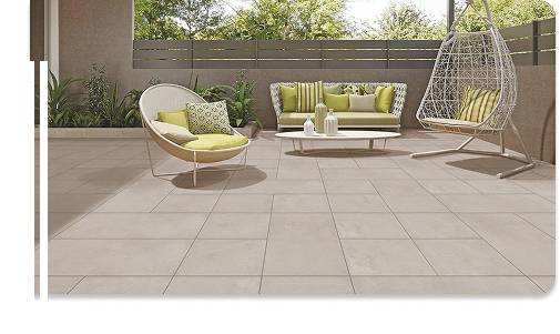Modern patio with beige tiles and stylish outdoor seating