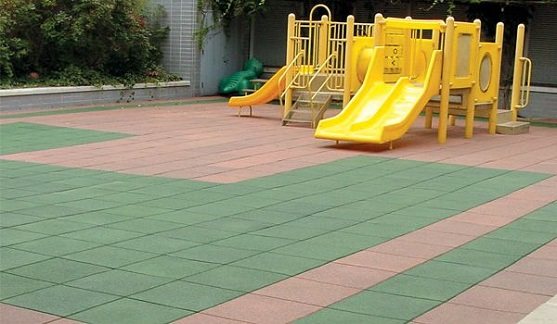 Playground with rubber safety flooring and yellow slides