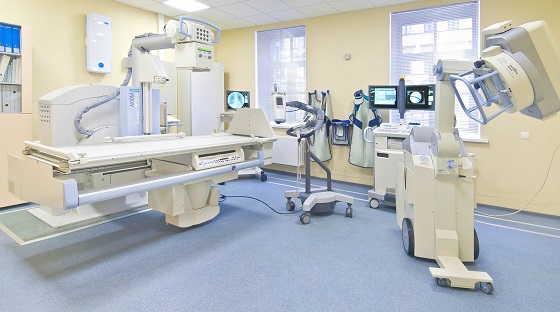 Radiology room with advanced imaging machines and blue flooring