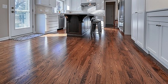 Rich brown engineered wood flooring in a bright modern kitchen