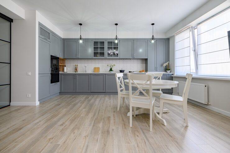 Spacious grey kitchen with light wood-look flooring