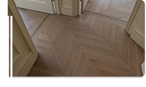 Chevron wooden flooring in hallway interior