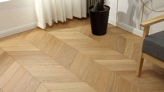 Light oak chevron flooring in a cozy corner interior