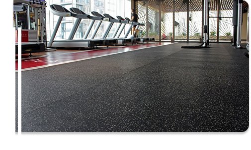 Treadmills on black EPDM rubber flooring with white speckles