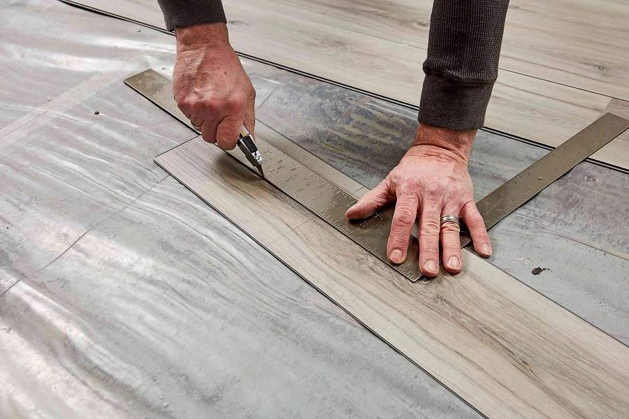 a man Cutting a vinyl plank